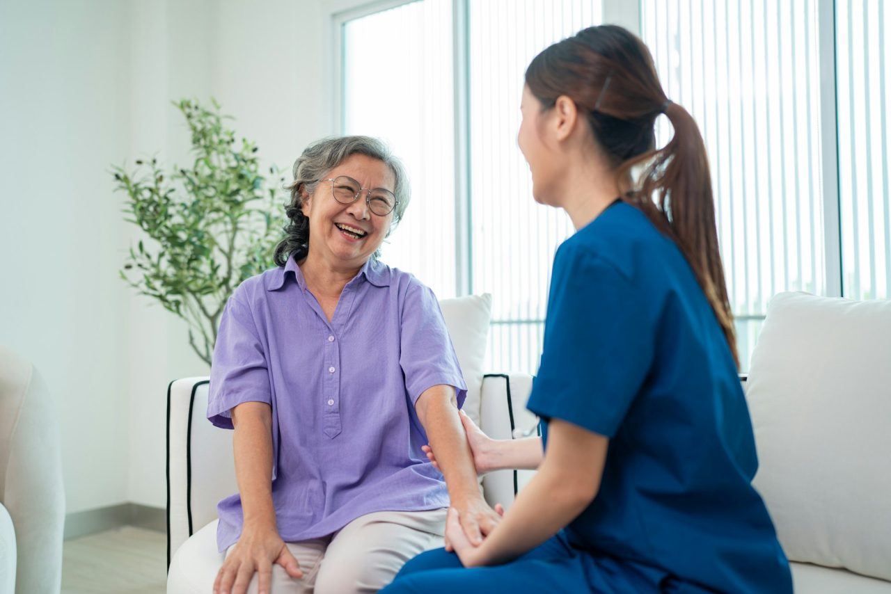 Female doctor taking care and talking mature female patient